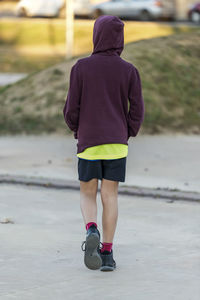 Low section of woman walking on footpath