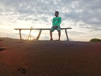 Full length of man standing on field against sky