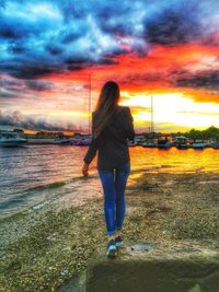 Rear view of woman standing on beach