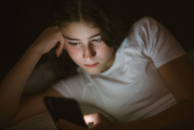 Young woman using mobile phone at home