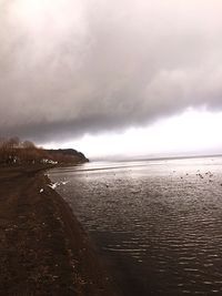 View of beach against cloudy sky