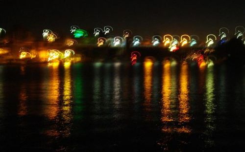 Reflection of illuminated lights in puddle