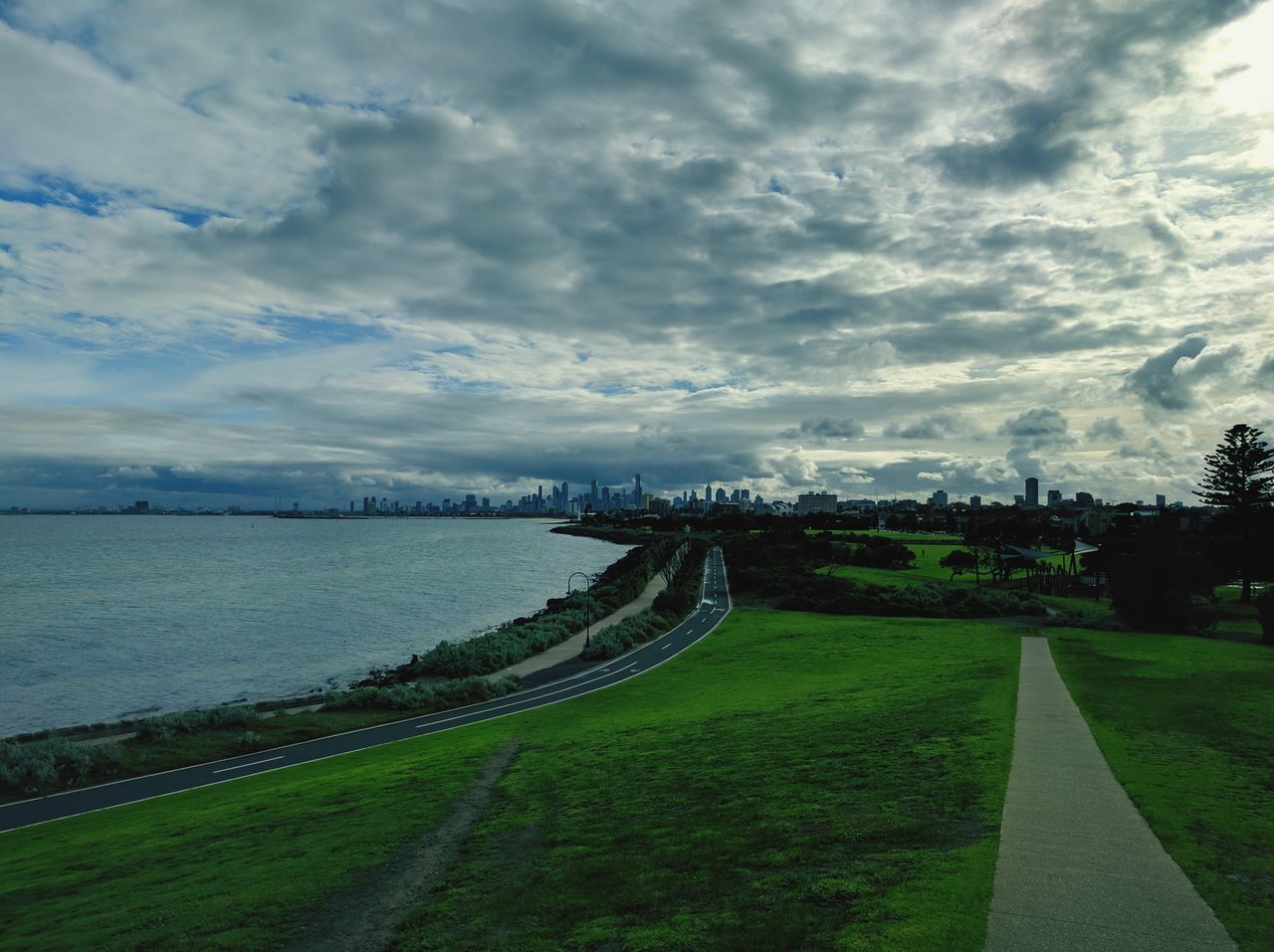 SCENIC VIEW OF RIVER BY ROAD AGAINST SKY