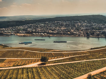 High angle view of cityscape by sea against sky