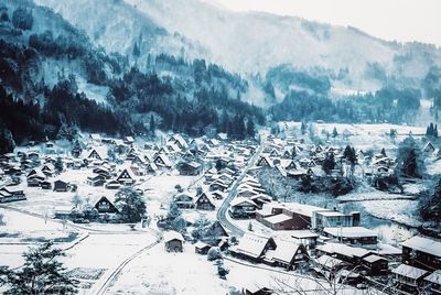 Aerial view of snow covered trees and buildings