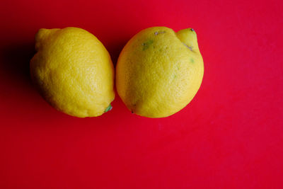 Close-up of fruits against red background