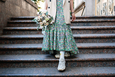 Contemporary modern trendy hipster bride in informal dress and sneakers with edible wedding bridal