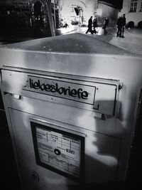 Information sign on street in city at night