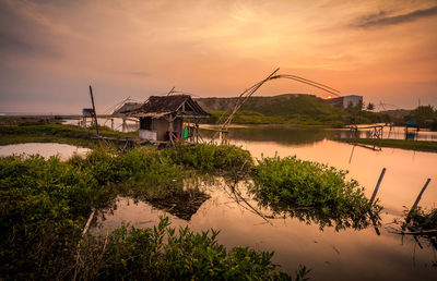 Scenic view of lake against sky during sunset