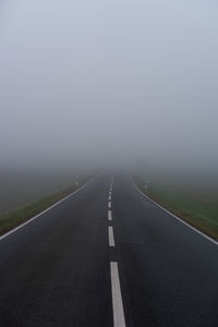 Empty country road against sky