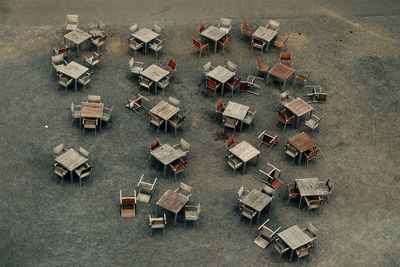 High angle view of empty chairs and tables arranged on street