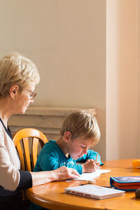 Boy and son on table