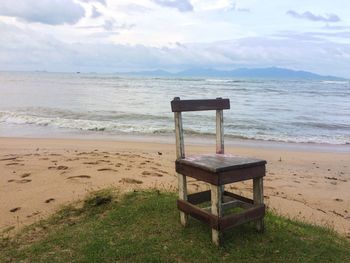 Lifeguard hut on beach against sky