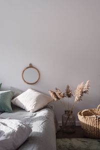 Wicker basket by plant in bedroom