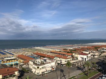 High angle view of buildings by sea against sky