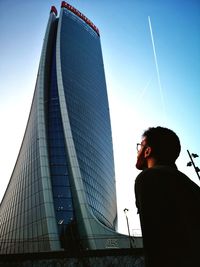 Low angle view of boy against sky