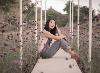 Portrait of young woman sitting on field