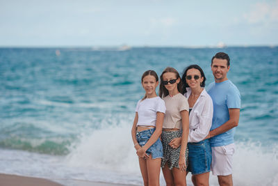 Friends standing at beach