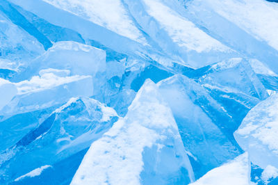 Aerial view of frozen lake against blue sky