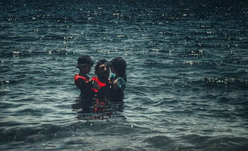 Father with son and daughter in sea