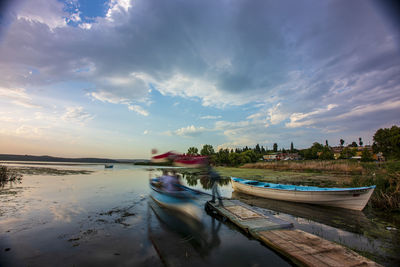 Boats moored on sea against sky