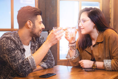 Young woman drinking glasses on table at restaurant