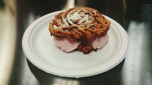 High angle view of ice cream funnel cake in plate on table