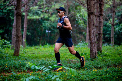 Full length of man running in forest