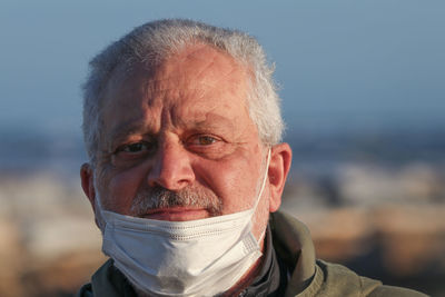 Close-up portrait of man wearing mask