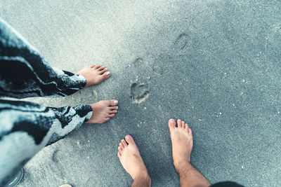 Low section of people standing on beach