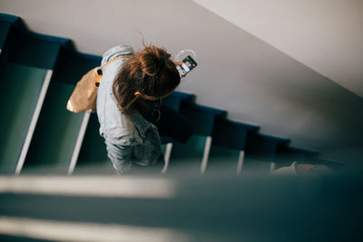 High angle view of woman standing by railing