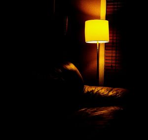 View of illuminated lamp in dark room