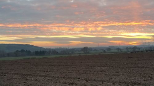 Scenic view of field against sky during sunset