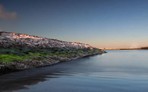 Scenic view of sea against clear sky during sunset