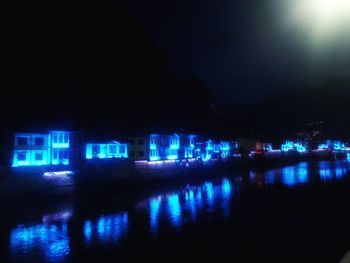 Illuminated reflection of water in sky at night