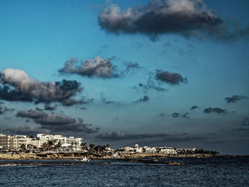 Panoramic view of sea and buildings against sky