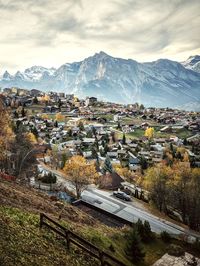 High angle view of houses and mountains against sky