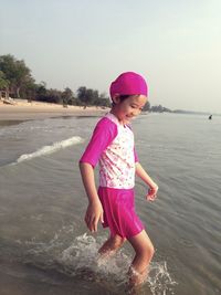 Full length of girl playing in water