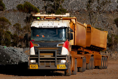 View of vehicles on road along trees