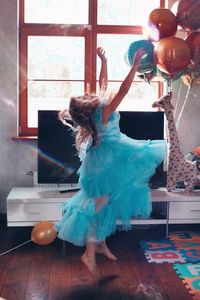 Woman playing with ball at home