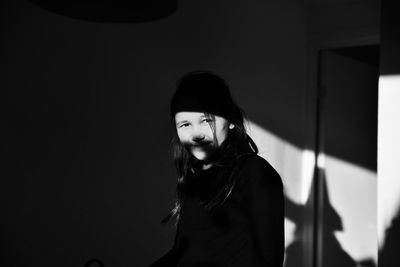 Portrait of smiling girl in darkroom