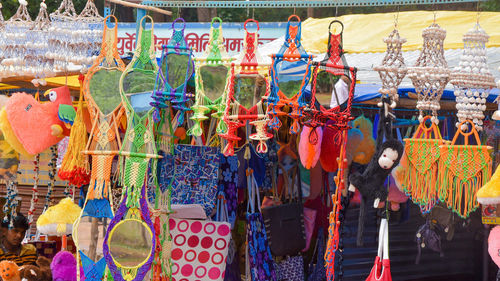 Multi colored decorations hanging at market stall