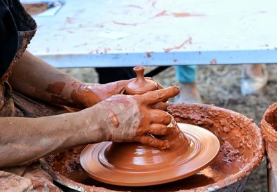 Close-up of man working in mud