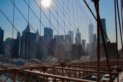 View of suspension bridge in city against sky