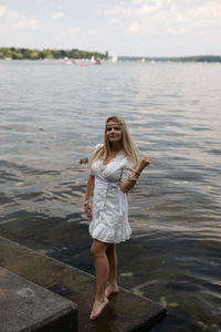 Full length portrait of a young woman in water