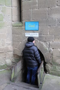 Man standing on brick wall