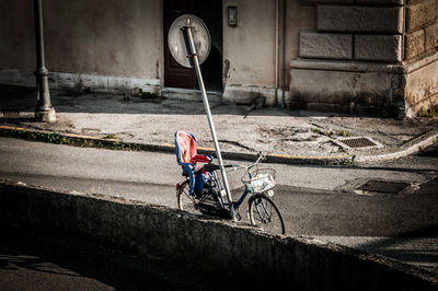 Man with bicycle on road in city