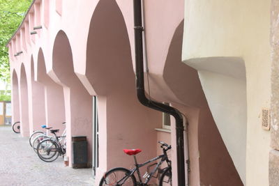 Bicycle leaning on railing against building