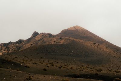 Scenic view of arid landscape against clear sky