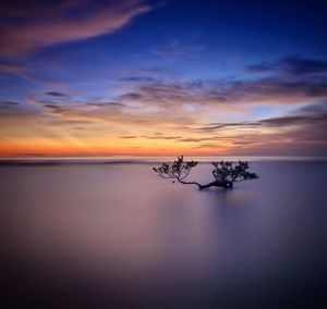 Scenic view of sea against sky at sunset